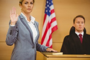 Witness swearing on the bible telling the truth in the court room